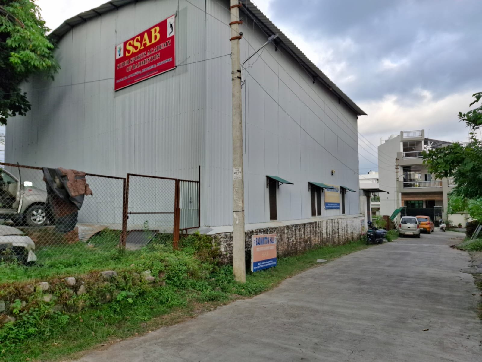 The SSAB hall from the lane outside, with the red Super Sports Academy of Badminton board above the entrance